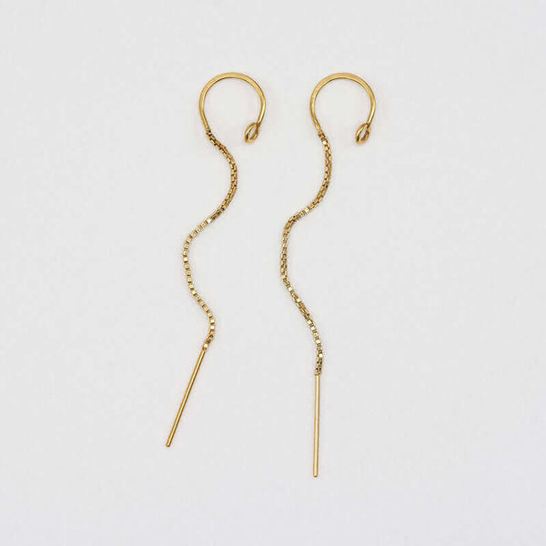 Pair of gold earrings, with open hoop with thin chain hanging down.