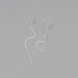 Pair of silver earrings, with open hoop with thin chain hanging down.