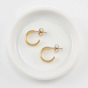 Pair of small gold open hoop earrings on posts.