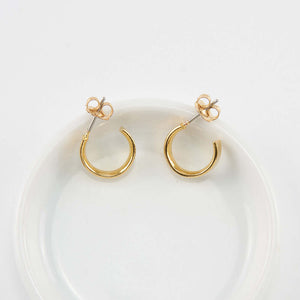 Pair of small gold open hoop earrings on posts.