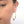 Load image into Gallery viewer, Close up front view of woman wearing pair of gold geometric native motif hoop earrings.
