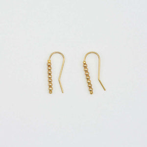 Pair of small gold wire earrings with gold beads.