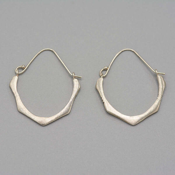 Pair of cast brushed silver hoop style earrings.