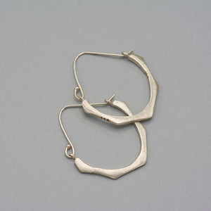 Pair of cast brushed silver hoop style earrings.