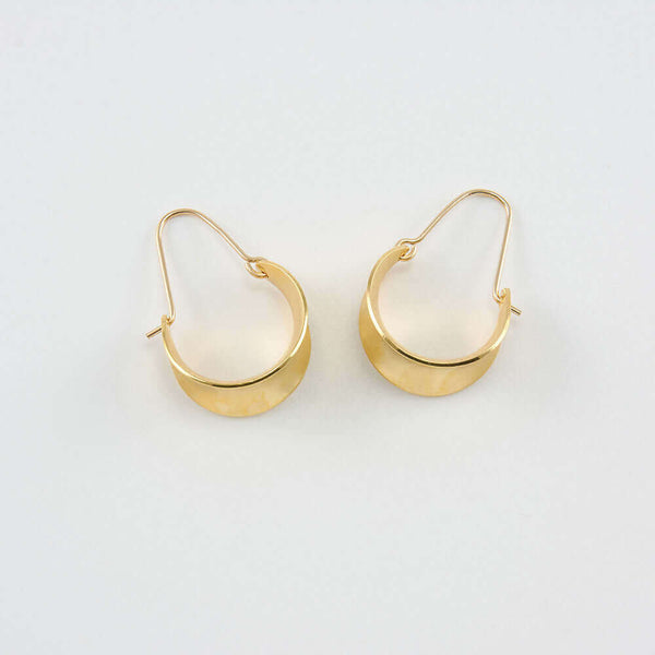 Pair of gold concave curved hoop earrings.