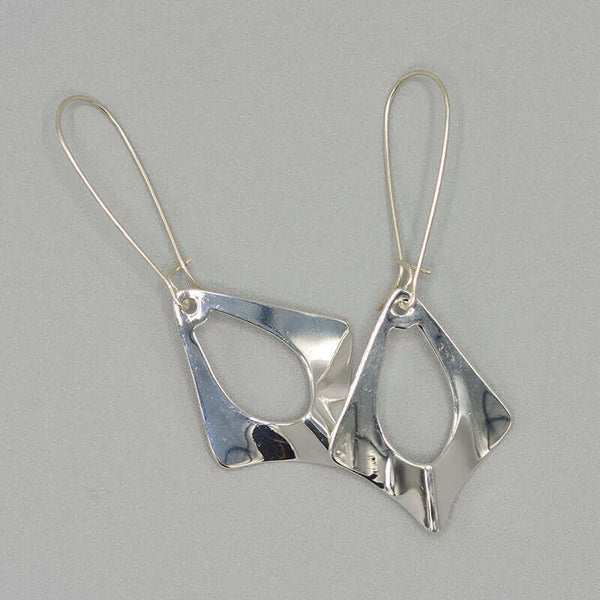 Pair of silver earrings, flat diamond shape with oval cutout on french earwire.
