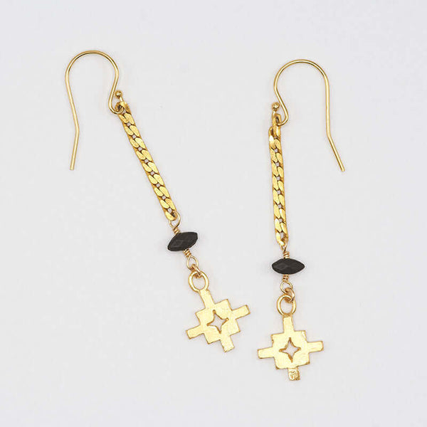 Pair of gold flat chain earrings with geometric cross at end.
