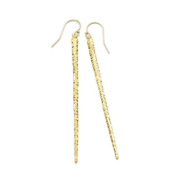 Pair of long gold earrings of thin cast feather on earwire.