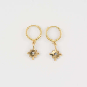 Pair of gold native motif cross earrings on hoop clasp.