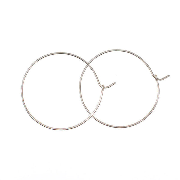 Pair of simple silver hoop earrings with loop and hook as clasp.