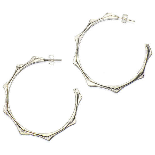 Pair of silver cast hoop earring on post with sun motif.