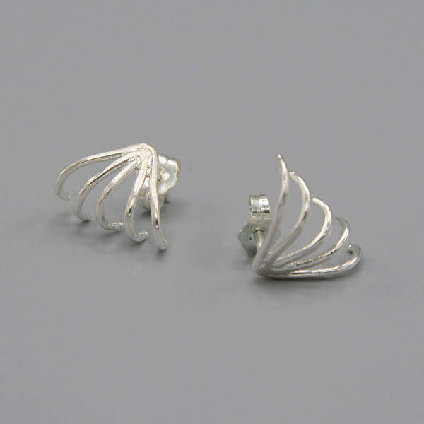 Pair of silver earrings with 5 gold wires that wrap around earlobes.