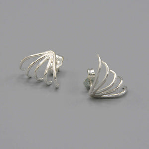 Pair of silver earrings with 5 gold wires that wrap around earlobes.