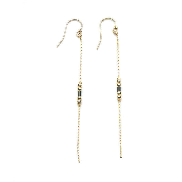 Pair of gold earrings, gold chain with black bead details.