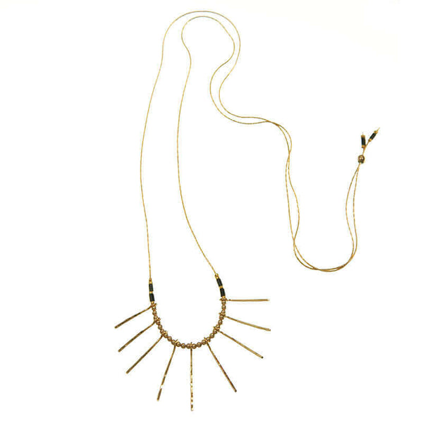 Delicate gold necklace, with a pendant of sunlight like rays, with adjuster bead at end to shorten length.