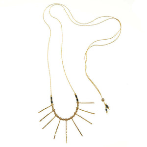 Delicate gold necklace, with a pendant of sunlight-like rays and beads, adjuster bead at end to shorten length.