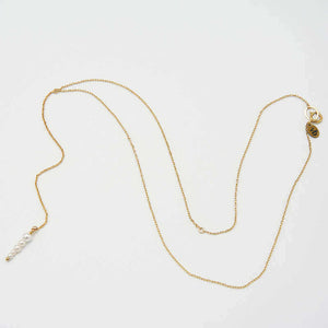 Delicate gold chain necklace with drop pendant of small pearl beads, laid out showing clasp.