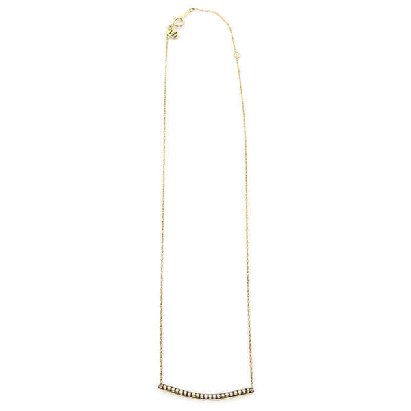 Close-up of gold chain necklace with curved beaded bar pendant, full length showing clasp.
