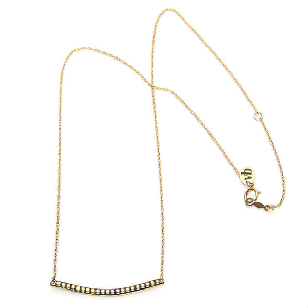 Close-up of gold chain necklace with curved beaded bar pendant, full length showing clasp.