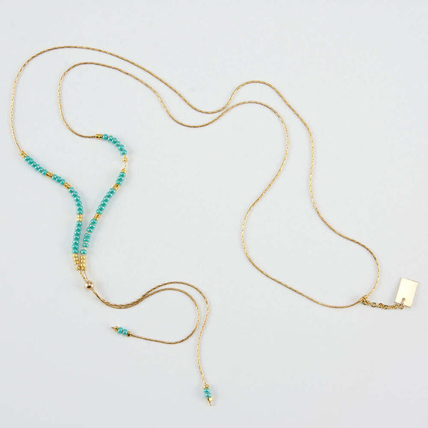 Delicate adjustable gold necklace with turquoise and gold beads and gold rectangle drop pendant.