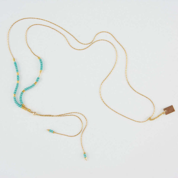 Delicate adjustable gold necklace with turquoise and gold beads and gold rectangle drop pendant.