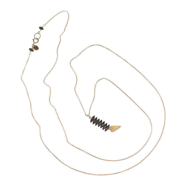 Delicate gold chain necklace with pendant of black beads and arrowhead.