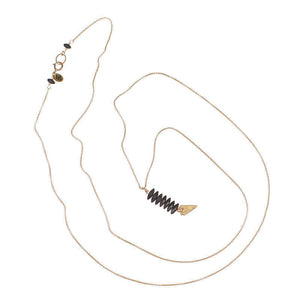 Delicate gold chain necklace with pendant of black beads and arrowhead.