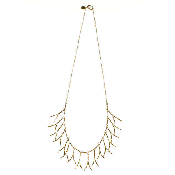 Delicate gold necklace with curved hanging frill design, shown full length.