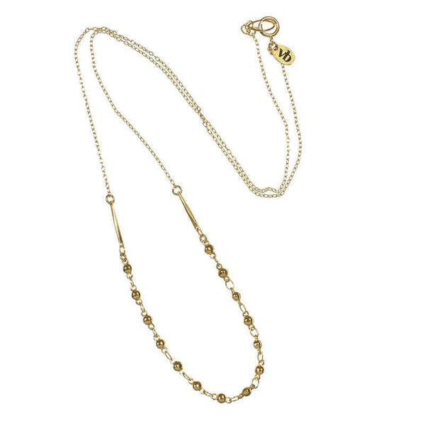 Delicate gold chain necklace with bead chain detail at bottom.