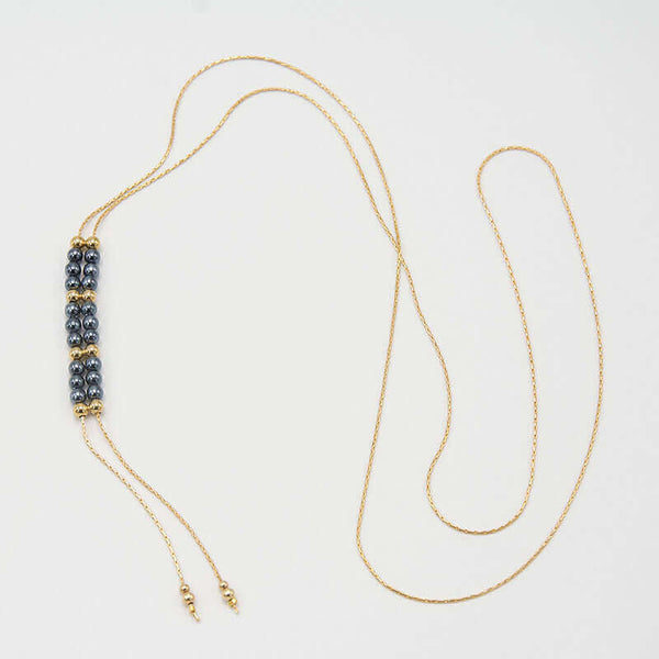 Gold chain necklace with pendant of double rows of dark pearls and gold beads, that slide to adjust length.