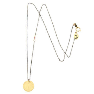 Black oxidized silver necklace with round brushed gold pendant.