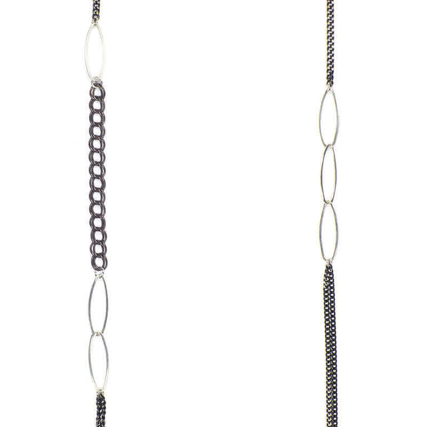 Close-up of long black oxidized silver multi-chain necklace with silver link details along chain.