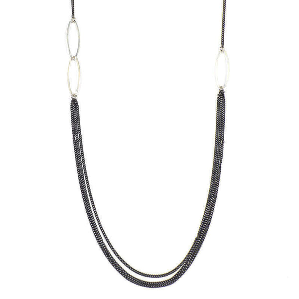 Close-up of short black oxidized silver multi-chain necklace with silver link details along chain.