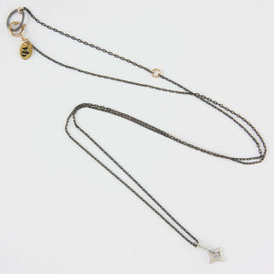 Delicate oxidized silver chain necklace with silver 4 point star pendant with inset diamond.