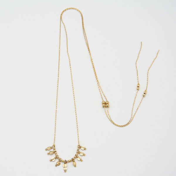 Adjustable delicate gold chain necklace with sliding beads and bottom.