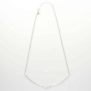 Silver necklace with curved bar pendant with geometric native motif.