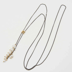 Black oxidized silver chain necklace with gold slider beads and pearls at the ends.