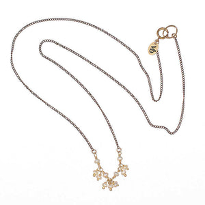 Delicate black oxidized necklace with small pearls as pendant.