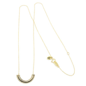 Gold necklace with beaded curved pendant.