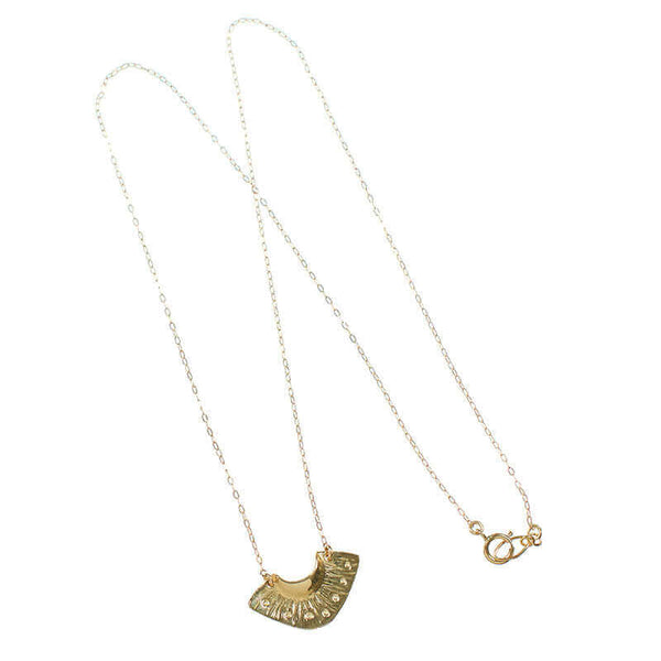 Dainty gold necklace with fan shaped pendant.