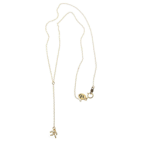 Dainty gold necklace with pendant of simple drop chain and tiny pearls.