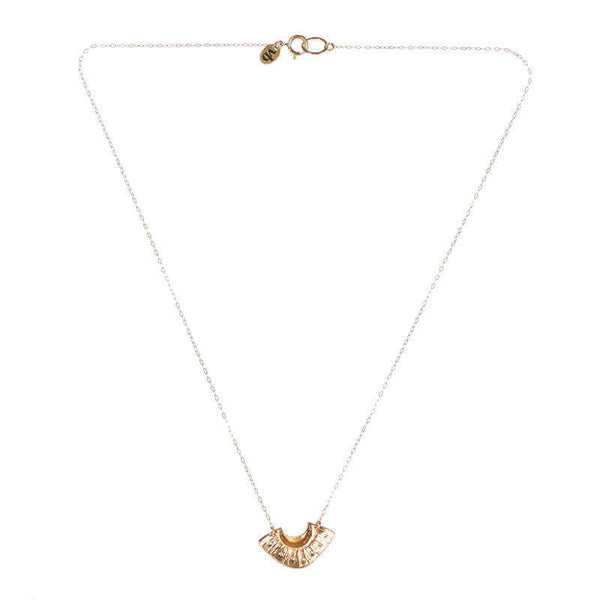 Dainty gold necklace with fan shaped pendant.