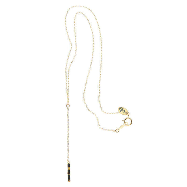 Dainty gold necklace with pendant of simple drop chain and black beads.