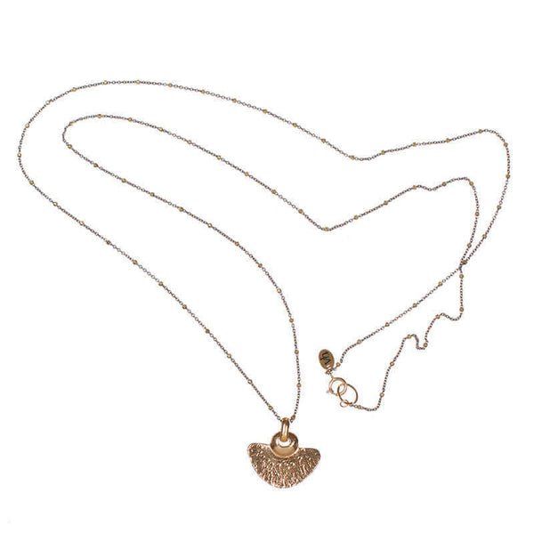 Delicate dark chain necklace with tiny gold beads along chain and gold half-circle shaped pendant.