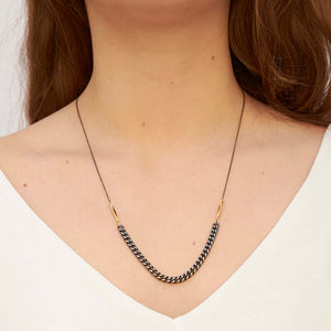 Woman wearing black oxidized chain necklace with vintage curb chain on bottom.