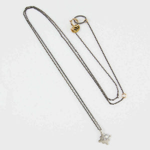 Delicate oxidized silver chain necklace with silver native motif cross pendant with inset diamond.
