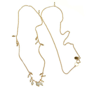 Gold necklace with small pearls on side and cluster of pearls as pendant.