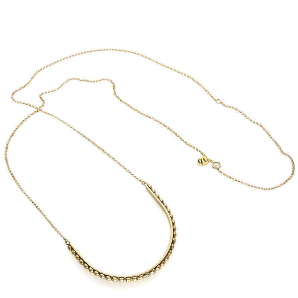 Gold necklace with large curved beaded bar pendant.