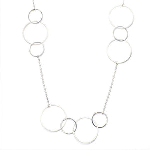 Close-up of silver necklace, groups of gold hoops on gold chain.