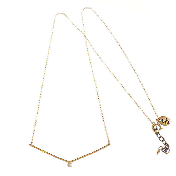 Delicate gold chain necklace, wide v pendant with white pearl in middle.